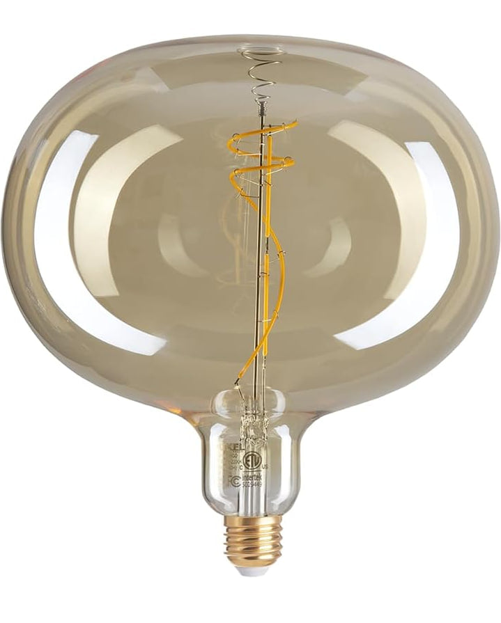 Close-up of oversized amber LED Edison bulb with spiral filament and reflective glass surface