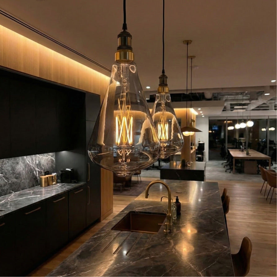 Modern kitchen interior with pendant lights and marble countertops