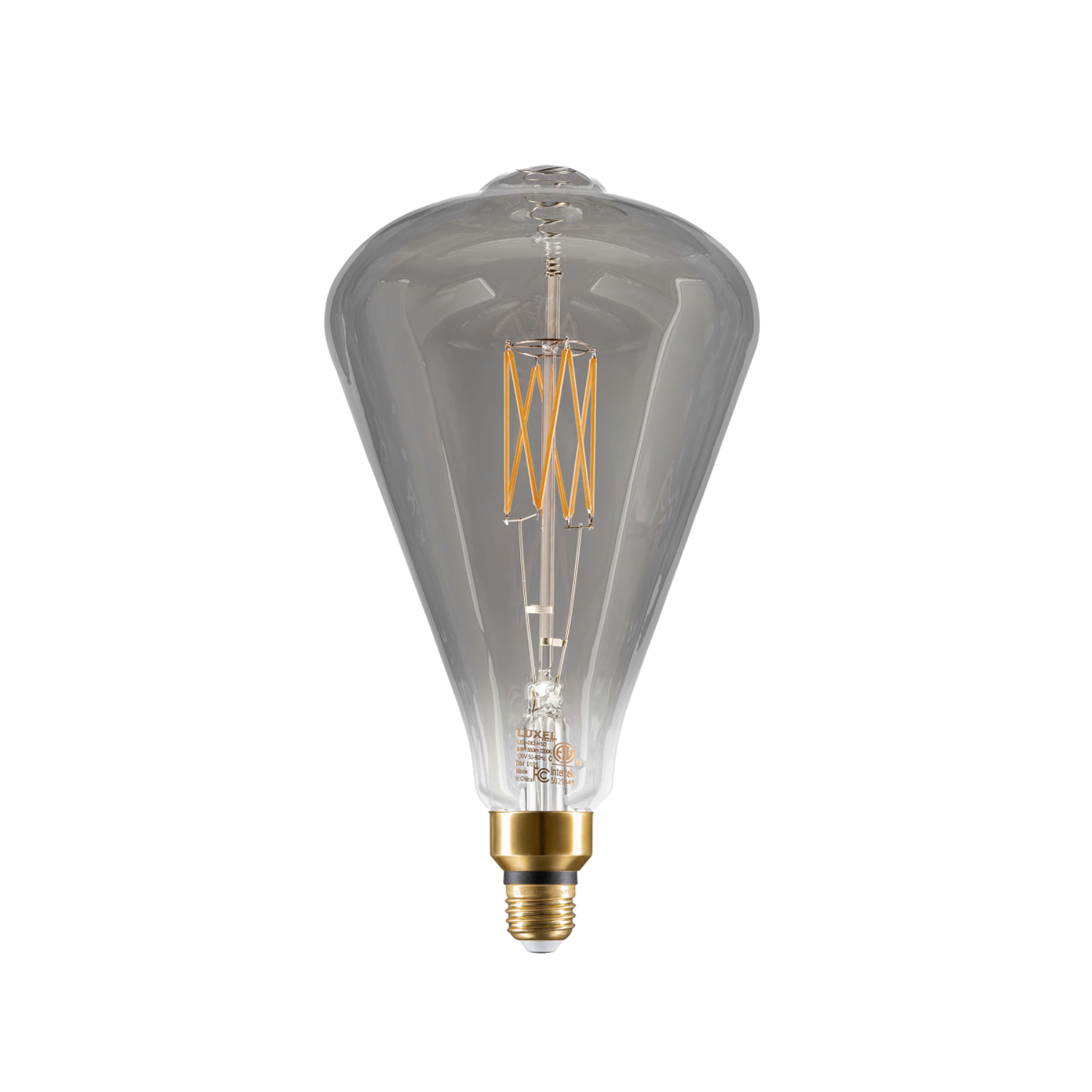 Hand holding oversized gold Edison-style LED bulb showing relative size