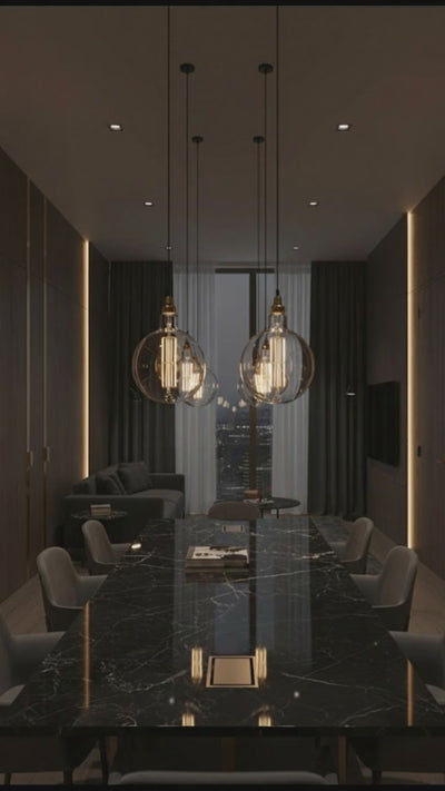 Vintage-style light bulbs hanging from the ceiling in a softly blurred room setting.